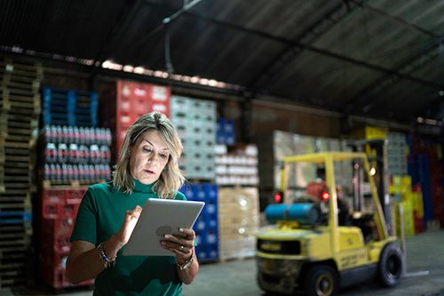 Woman holding tablet in a warehouse