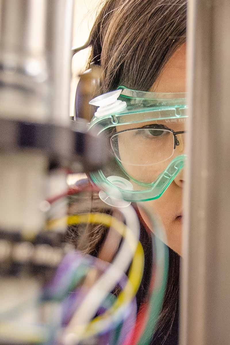 Female researcher looking at some wires