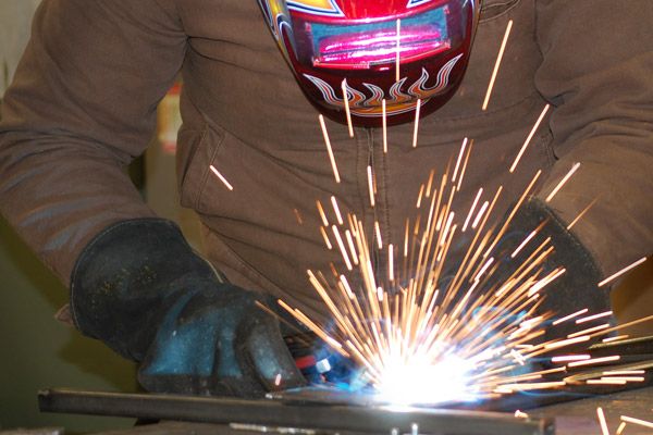A person welding with sparks flying.